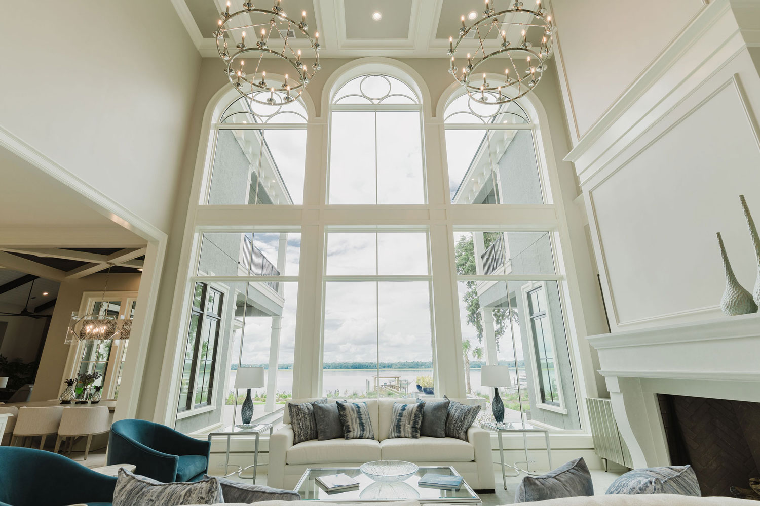 A photo showcasing the beautiful arched, two-story windows facing the beach in this newly built Hilton Head home.